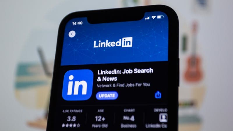 Smartphone displaying LinkedIn app where proper headshot dimensions matter