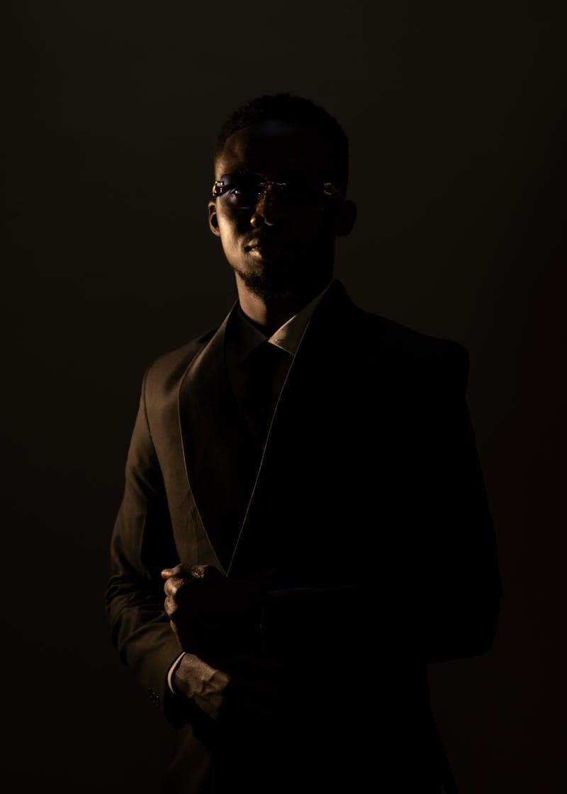 Commercial actor headshot with clean, approachable look and dramatic lighting