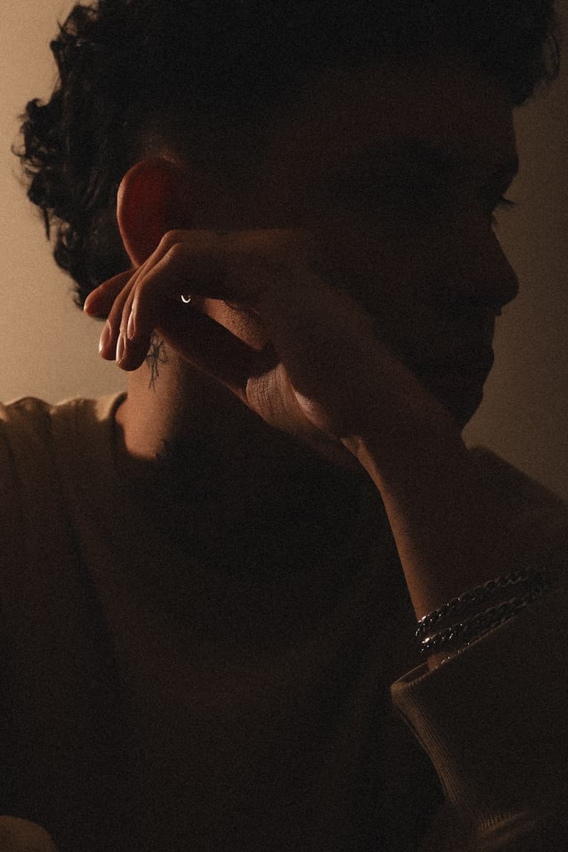Theatrical actor headshot with dramatic side lighting and moody atmosphere