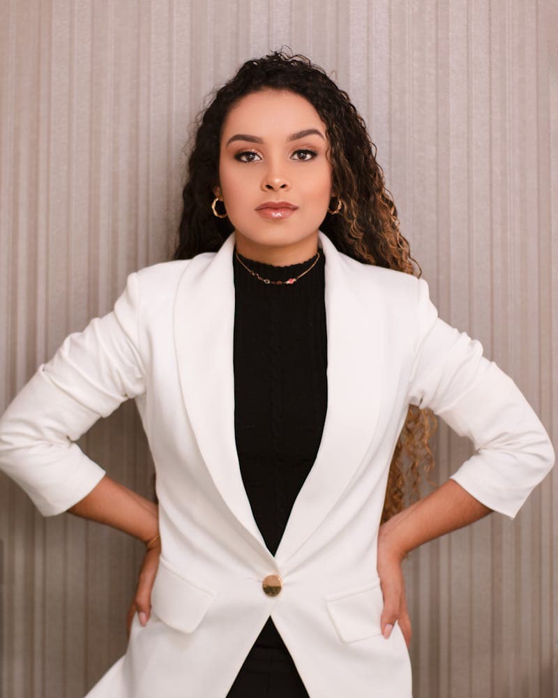 Professional woman in a white blazer showing how accessories complement a headshot outfit