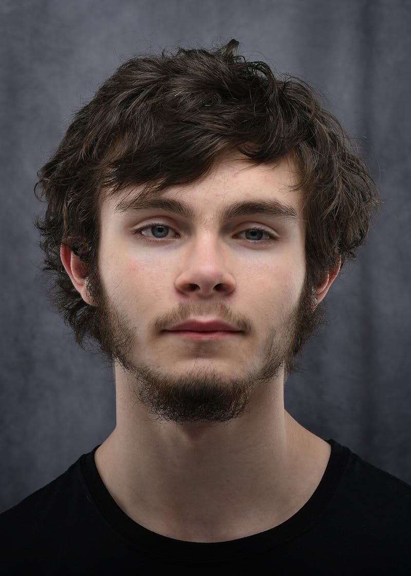 Professional studio headshot with controlled lighting and clean background