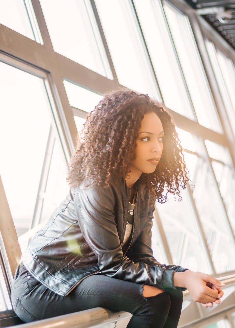Woman with a natural relaxed expression by a window, ideal for headshot photography