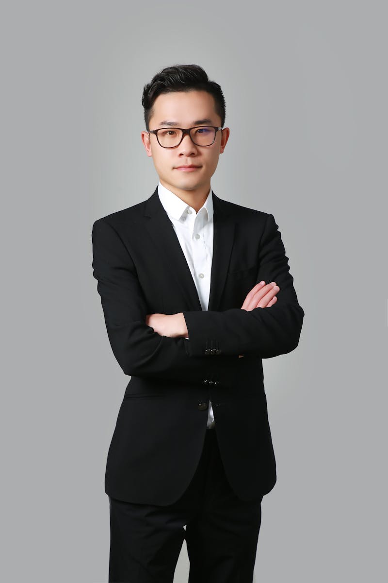 Professional demonstrating a confident headshot pose in a suit