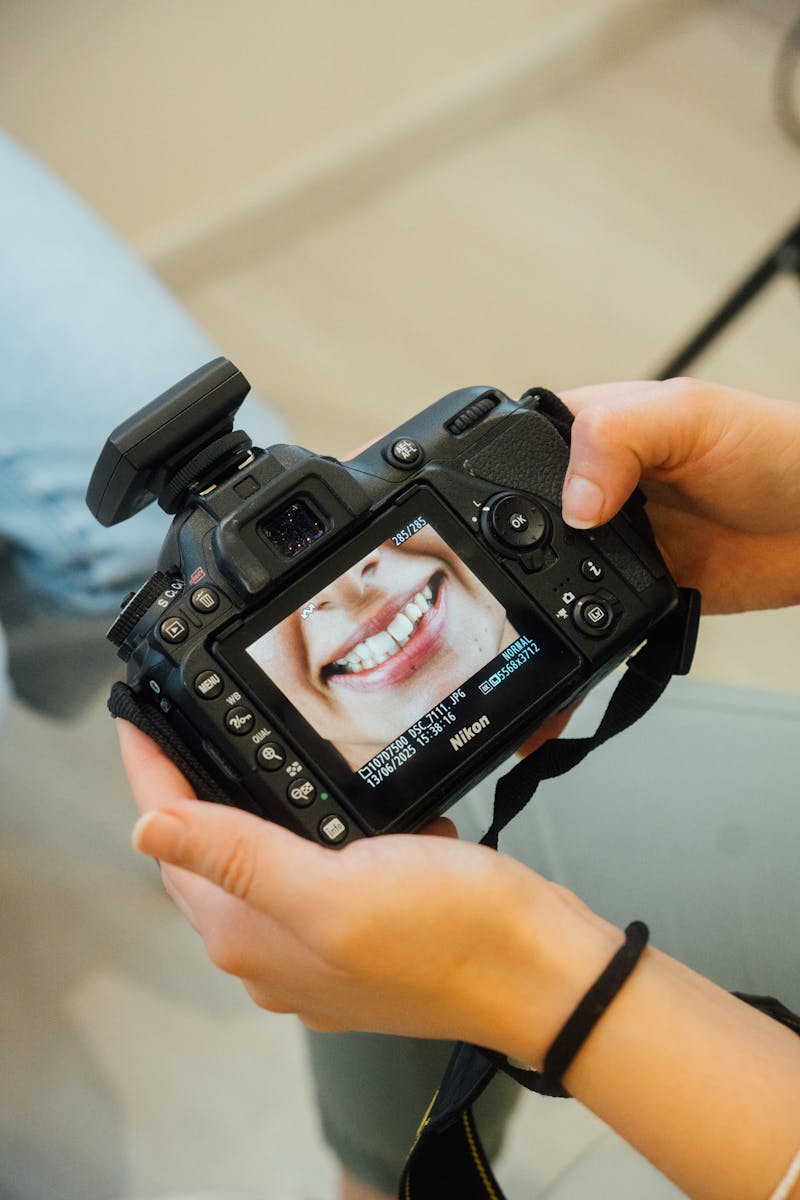 Photographer reviewing a portrait on camera during a headshot session