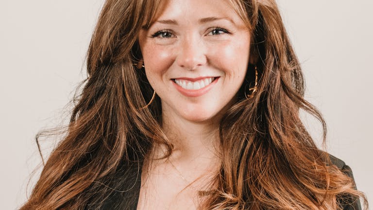 Person smiling naturally during a professional headshot session