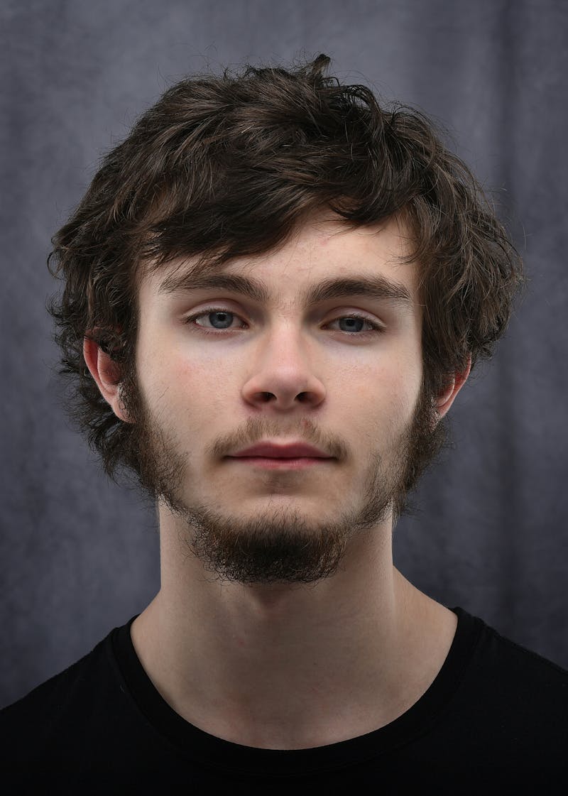 Professional studio headshot with controlled lighting and clean background