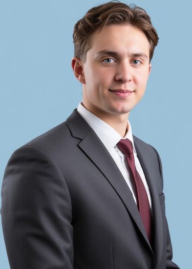 Professional headshot of a man in a gray suit and tie, AI headshot photo example